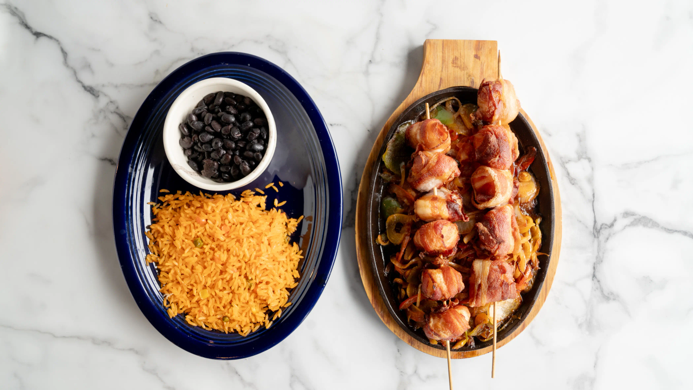 Ten jumbo shrimps, stuffed with cheese, and sliced jalapeños, wrapped in bacon. Served on a bed of mixed veggies, rice, and charro beans