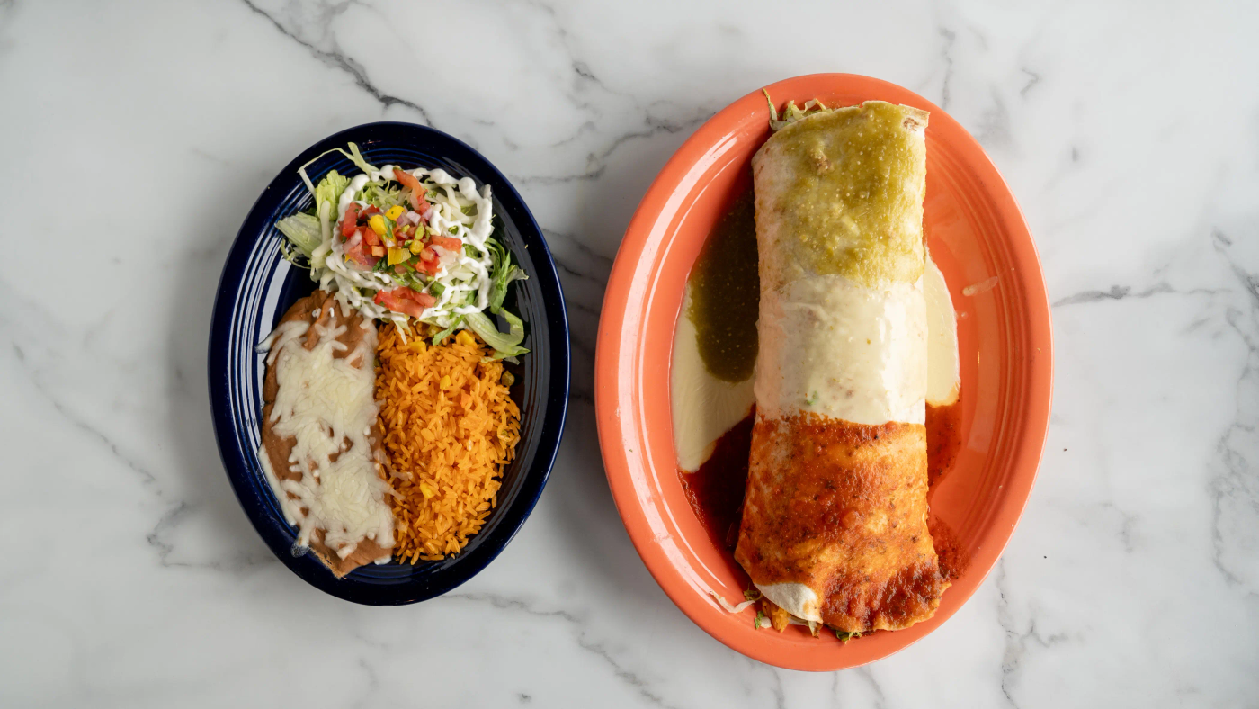 Extra large flour tortilla stuffed with your choice of meat, black beans, rice, lettuce, sour cream, fresh jalapeños, and pico de gallo. Covered with melted cheese, red and green sauce