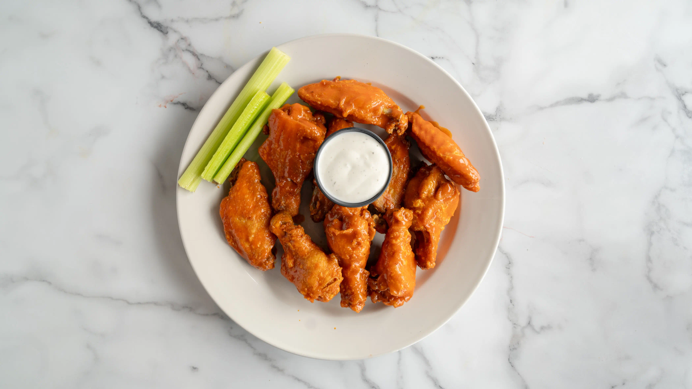 Ten wings tossed in your sauce of choice: plain, BBQ, buffalo, or mango habanero. Served with celery, blue cheese or ranch dressing