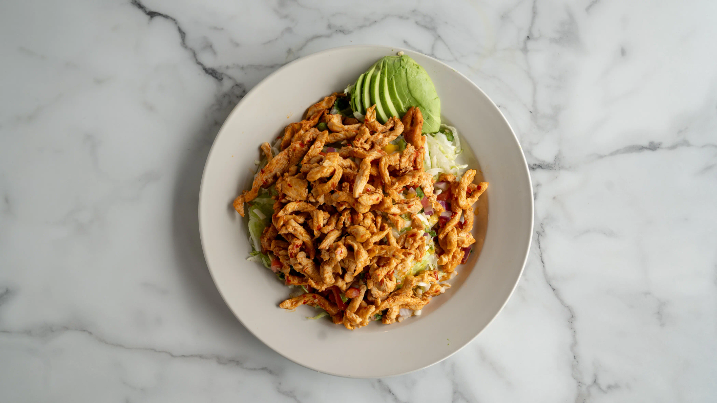 Grilled chicken, steak, or shrimp, served on a bed of lettuce with tomatoes, shredded cheese, and slices of avocado